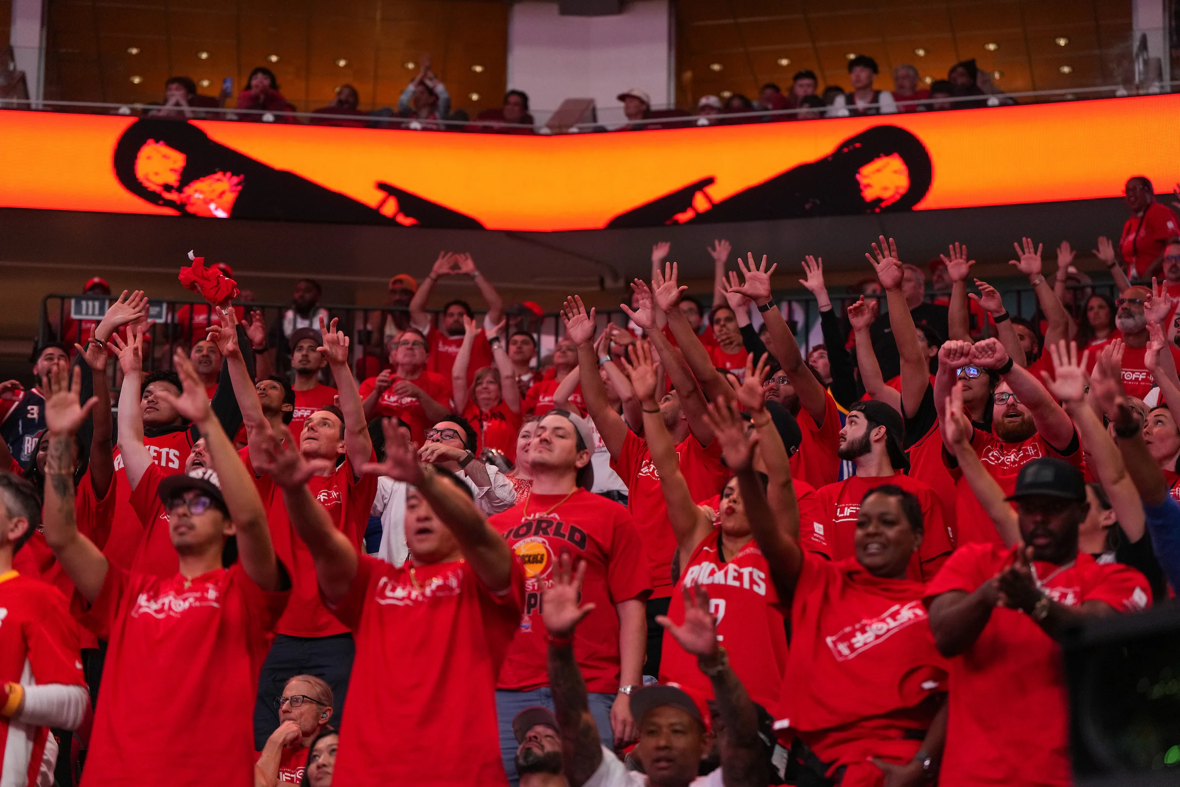 Crowd cheering and standing in the stands during a playoff game